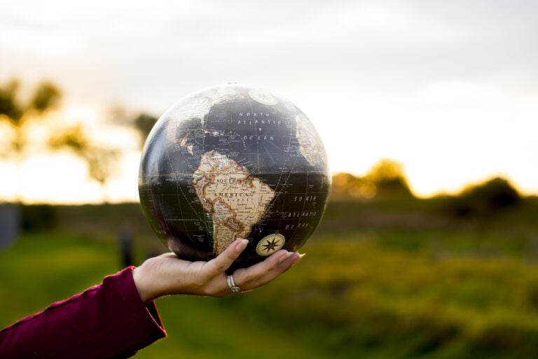A woman holding a globe